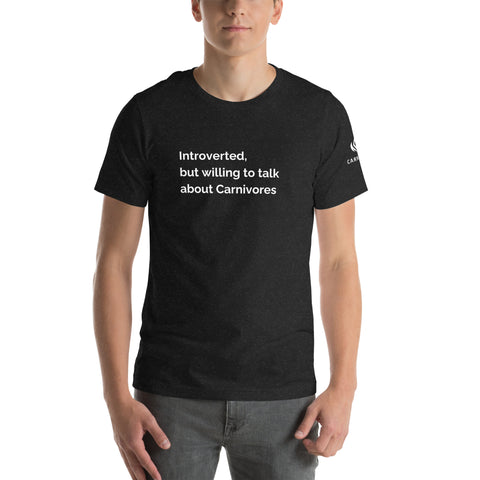 Black heathered tee on a model with a white slogan reading Introverted but willing to talk about Carnivores.